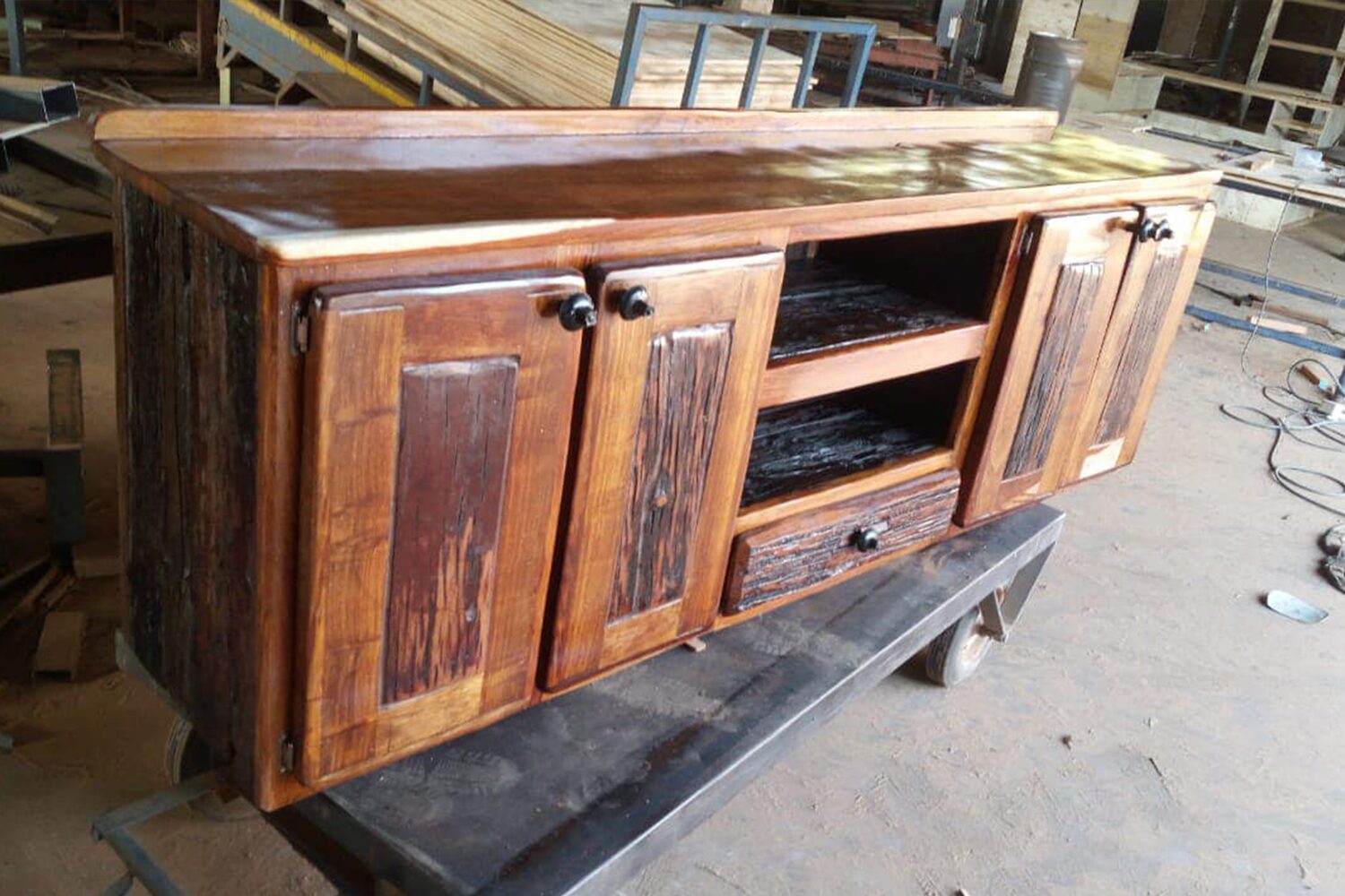 Rustic sleeperwood bed with a solid frame and a weathered wood finish, creating a cozy and natural bedroom atmosphere.